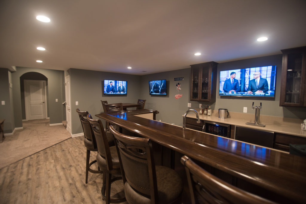 large sit at bar with seating and stained wood top