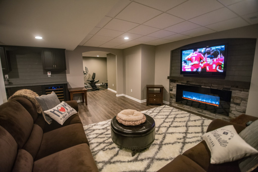 Northville Michigan cozy basement living room with electric fireplace and sectional