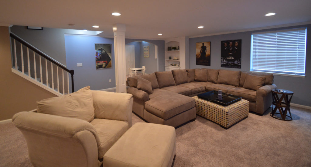 basement living room with plenty of couches and seating