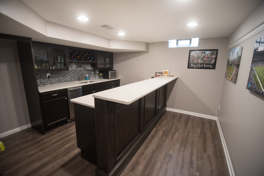 White granite countertops with dark stained cabinets