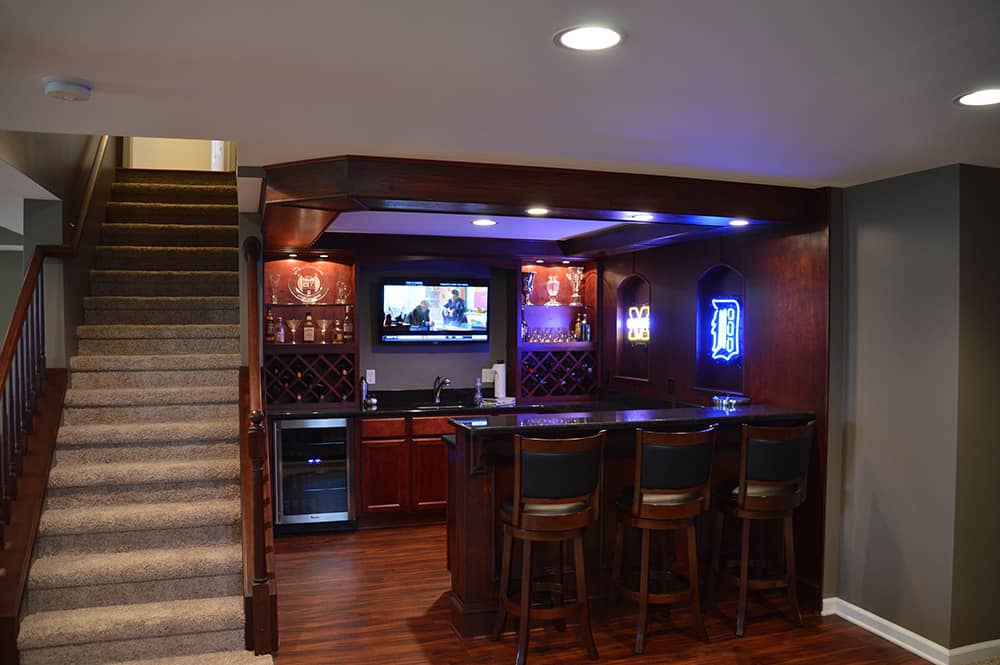 sports bar in basement detroit style dark cabinets and granite