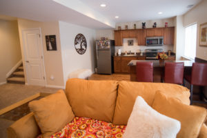 cozy family room in finished basement with large kitchen area and living room
