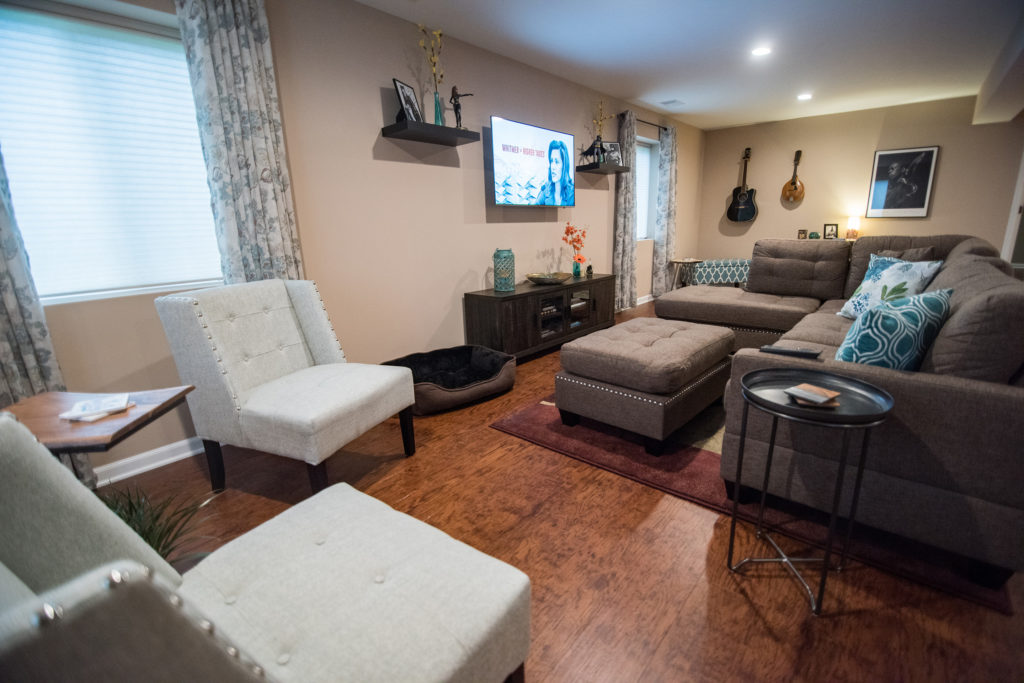 basement living room area with sectional for entertaining