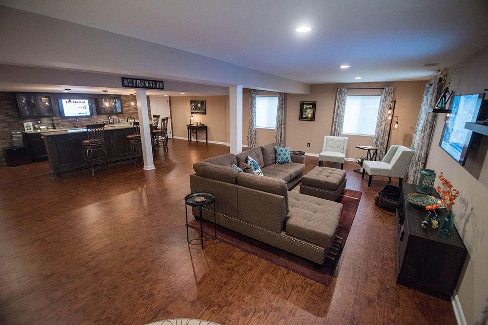 open concept basement with bar and living room