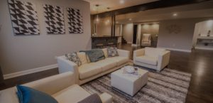 finished basement with dark plank flooring and grey walls with modern design