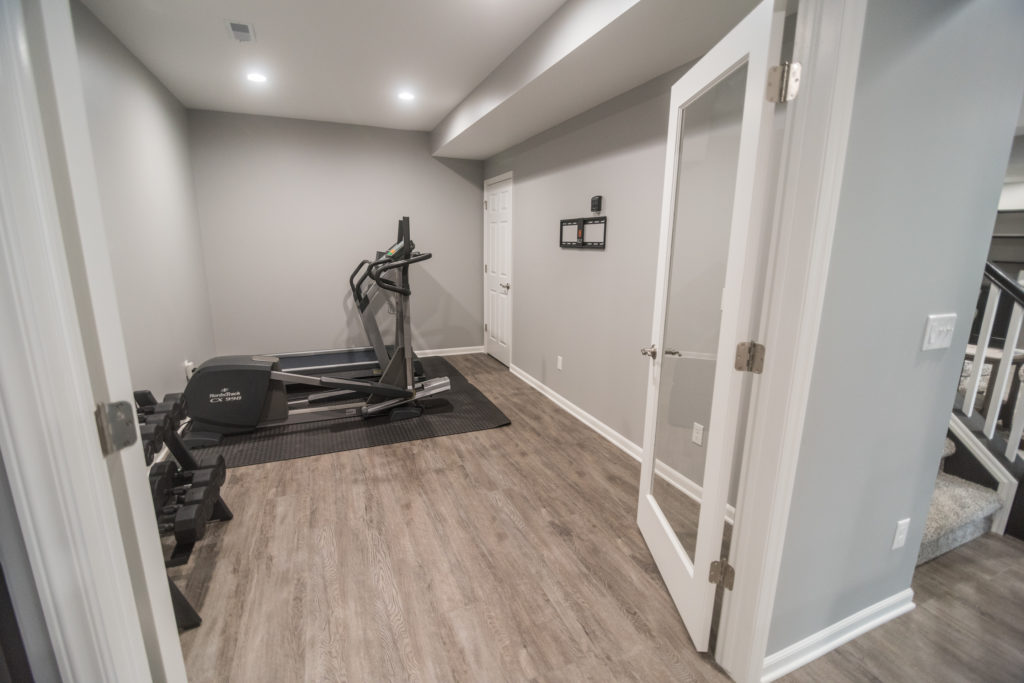finished basement home gym area with vinyl plank flooring