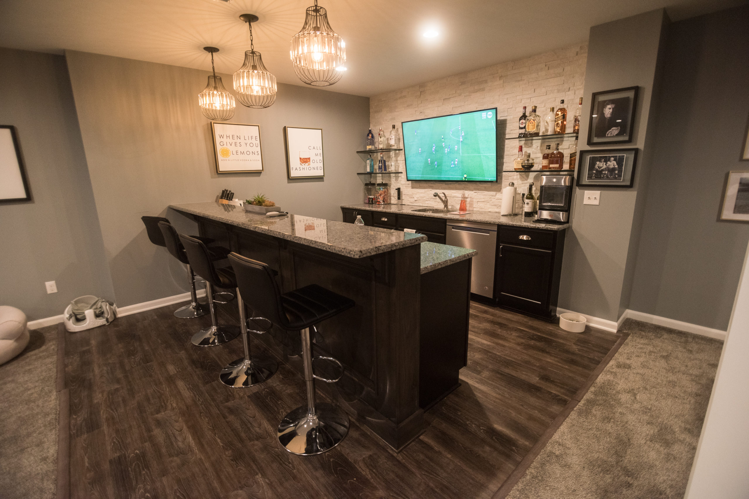 A bright inviting home bar with stone work on the walls and farmhouse style decorations