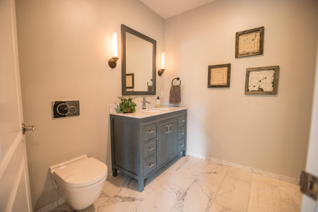 tile flooring in basement bathroom with blue vanity