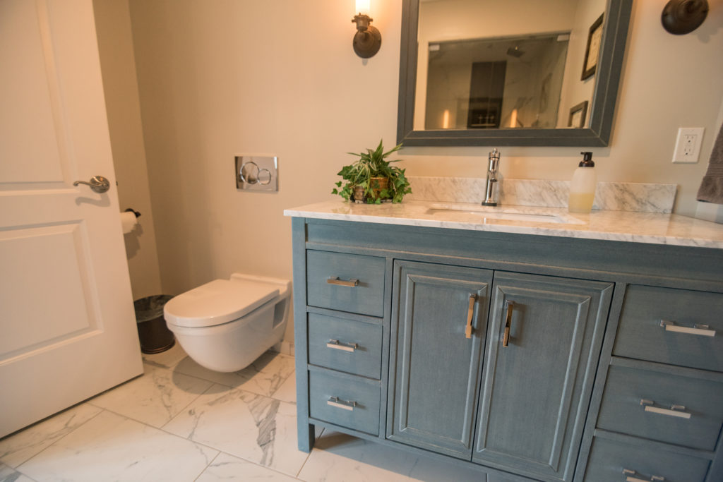 blue vanity in tiled bathroom for a pop of color