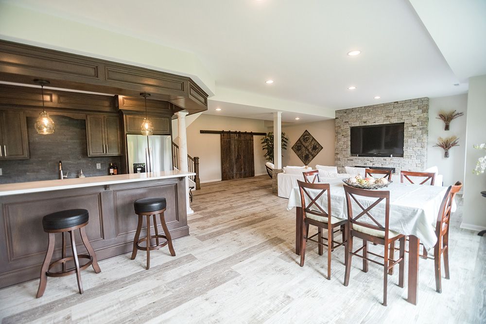 bar area in basement next to dining table and large living area