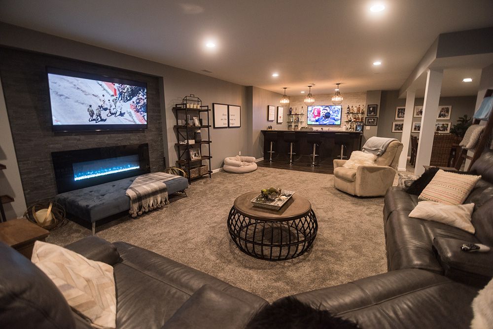 Finished Basement in South Lyon, MI with carpeting and a stone accent wall with fireplace
