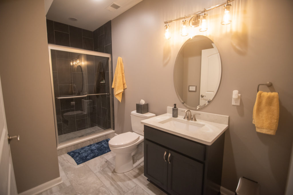 basement bathroom blue cabinetry