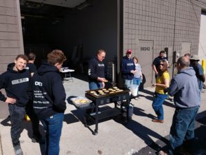 Finished basements team grilling outside