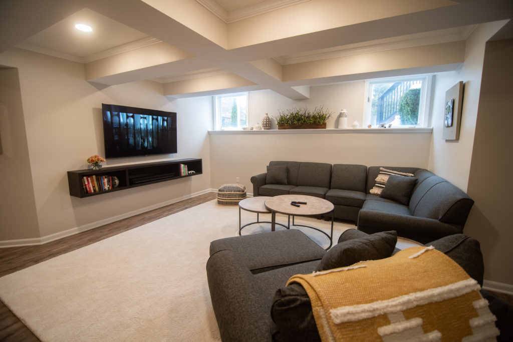 finished basement living room with media center and ceiling detail daylight wall