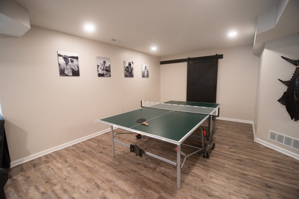 ping pong room with hickory vinyl plank flooring