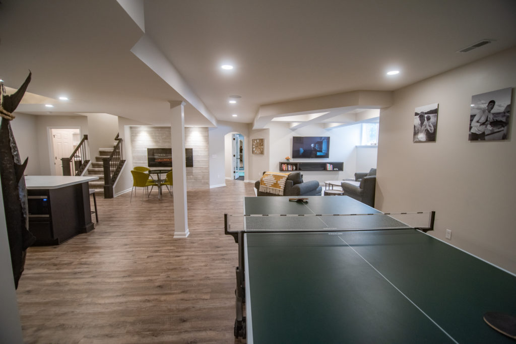 basement with ping pong table and vinyl plank flooring
