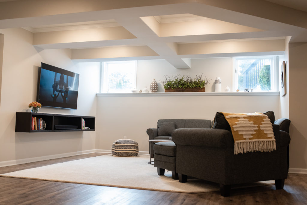 finished basement with rustic vinyl plank flooring and ceiling detail