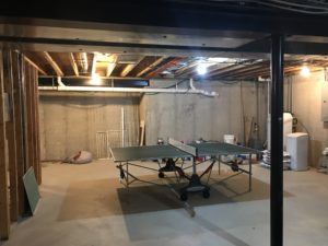 Ping pong table on cement in unfinished basement