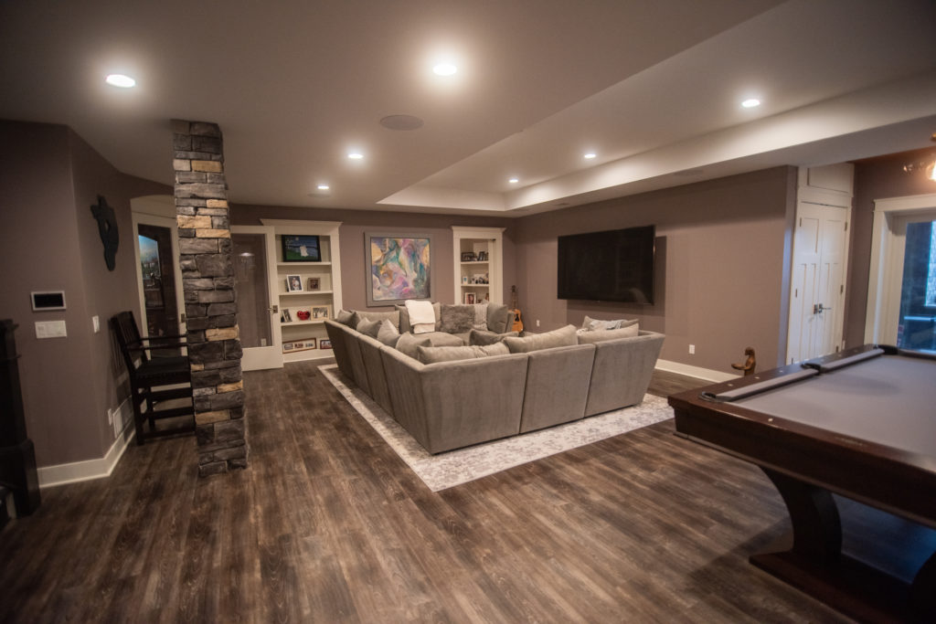 basement living room with detailed ceiling heights