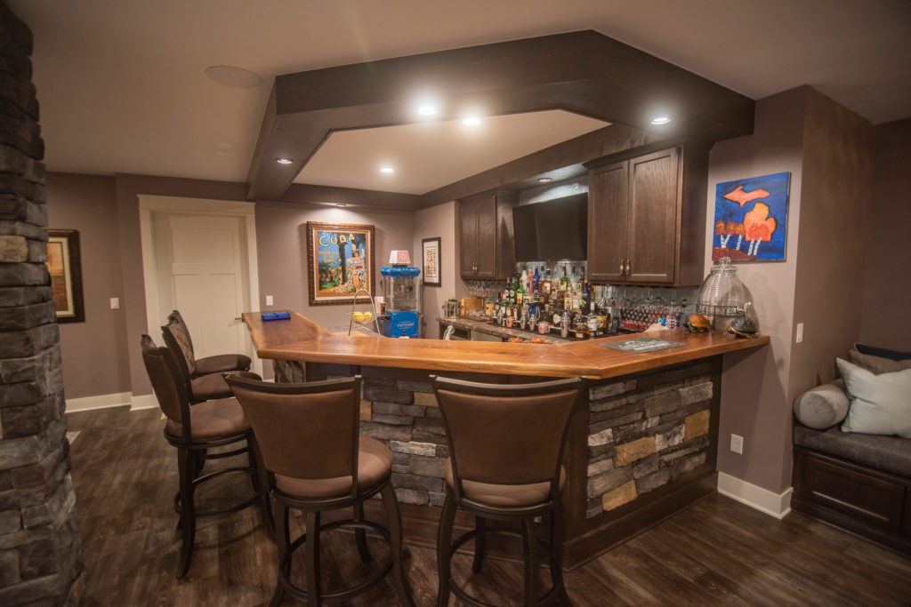 finished bar with wood countertops and wood soffit