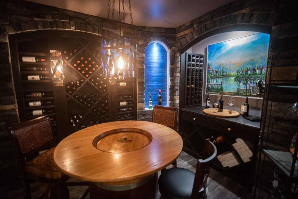 wine cellar with pendant lighting and wine racks