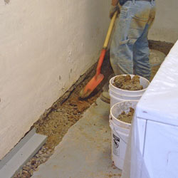 A perimeter drain system being installed