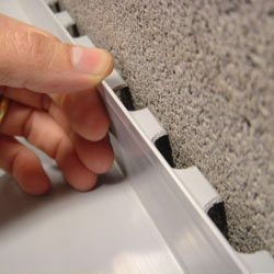 Hand placing finishing touches on finished basement