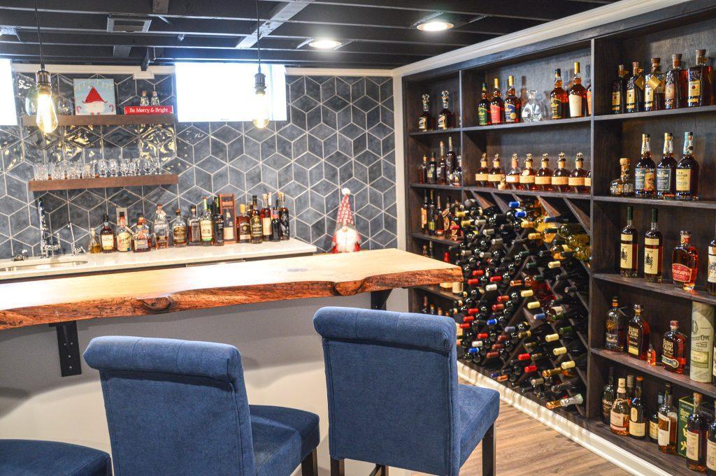 Finished basement home bar with custom wood countertop and wine rack wall in Farmington Hills, Michigan