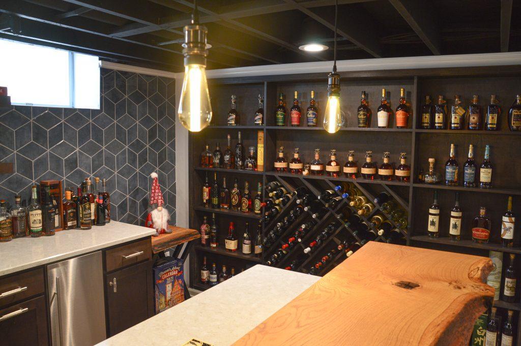 Finished basement home bar with custom wood countertop and wine rack wall in Farmington Hills, Michigan