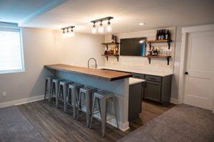 bar area with shelving and sink in renovated basement