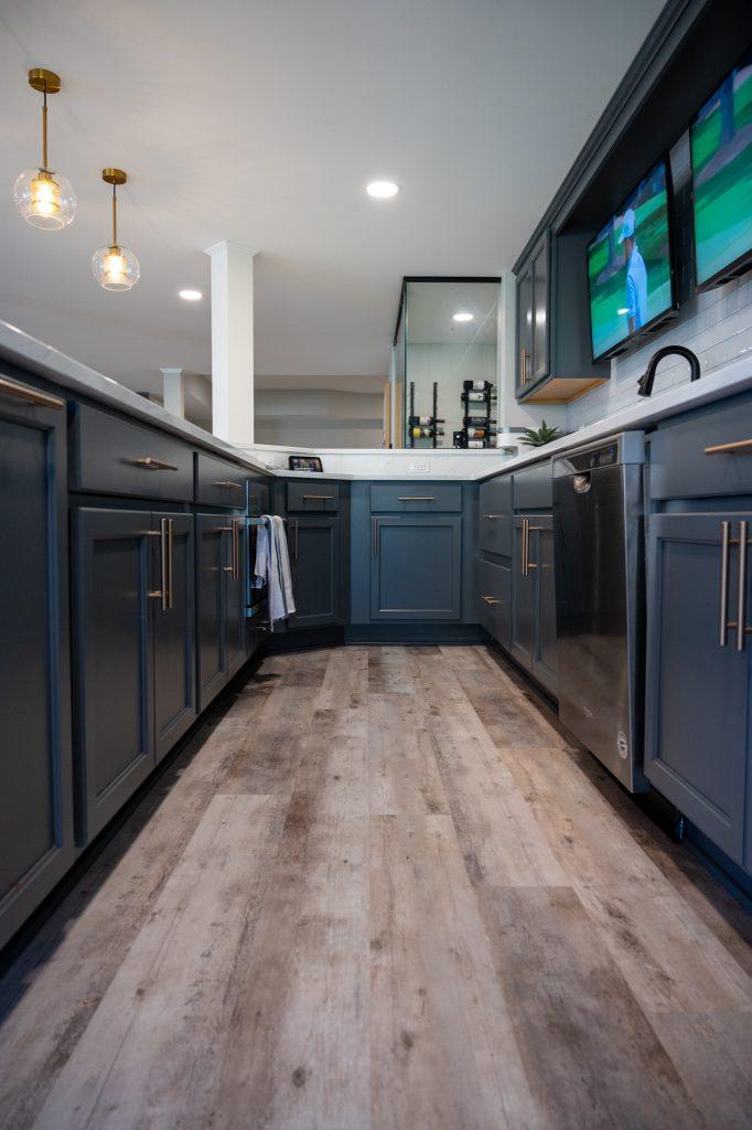 Finished basement home bar blue cabinets in Northville, Michigan