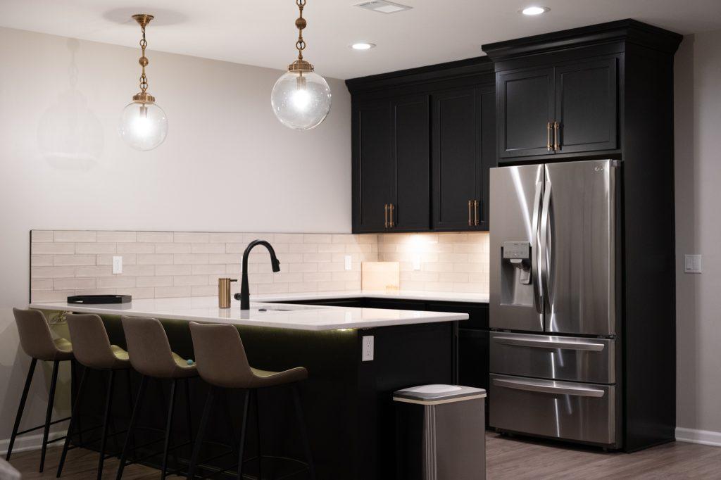 Finished basement bar area with black cabinets in Northville, Michigan