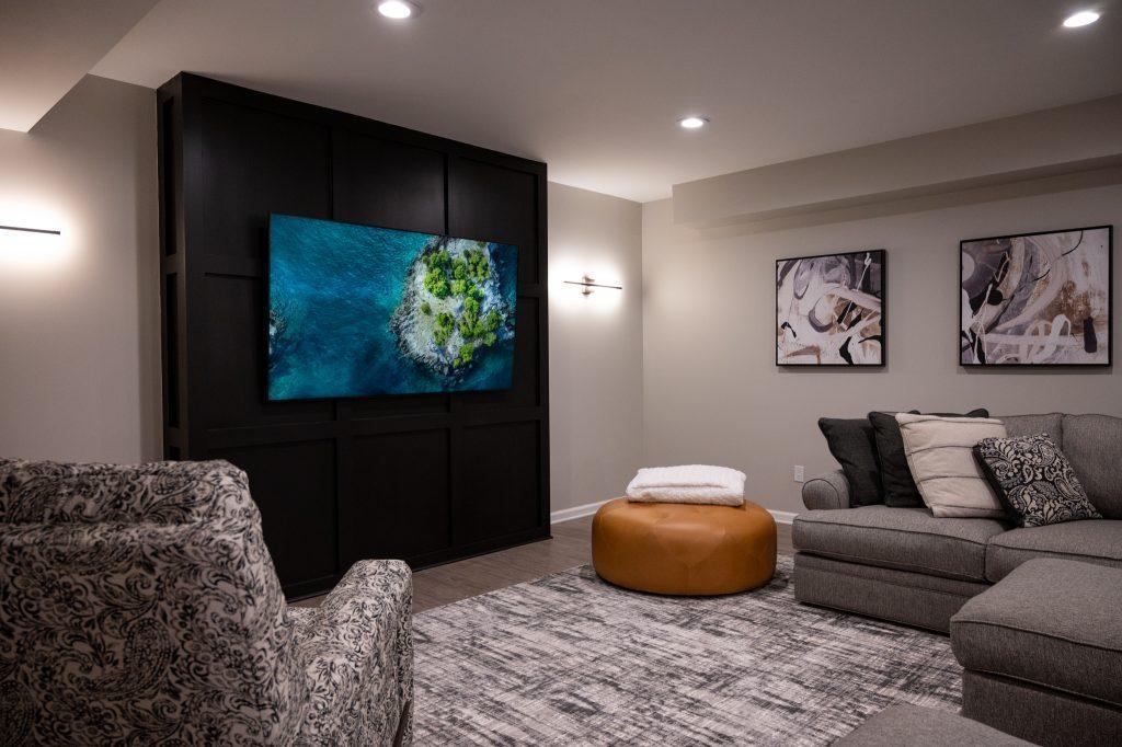 Finished basement living room with black accent wall in Northville, Michigan