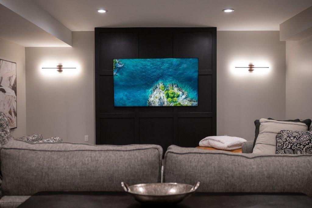 Finished basement living room with black accent wall in Northville, Michigan