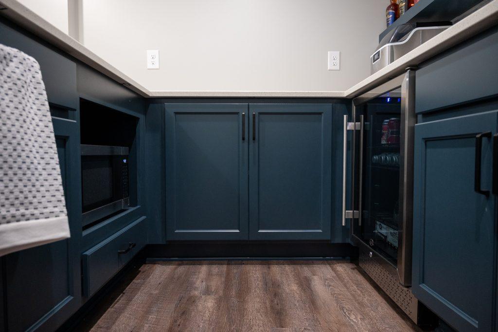 Finished basement blue cabinets in home bar in home bar in New Hudson, Michigan