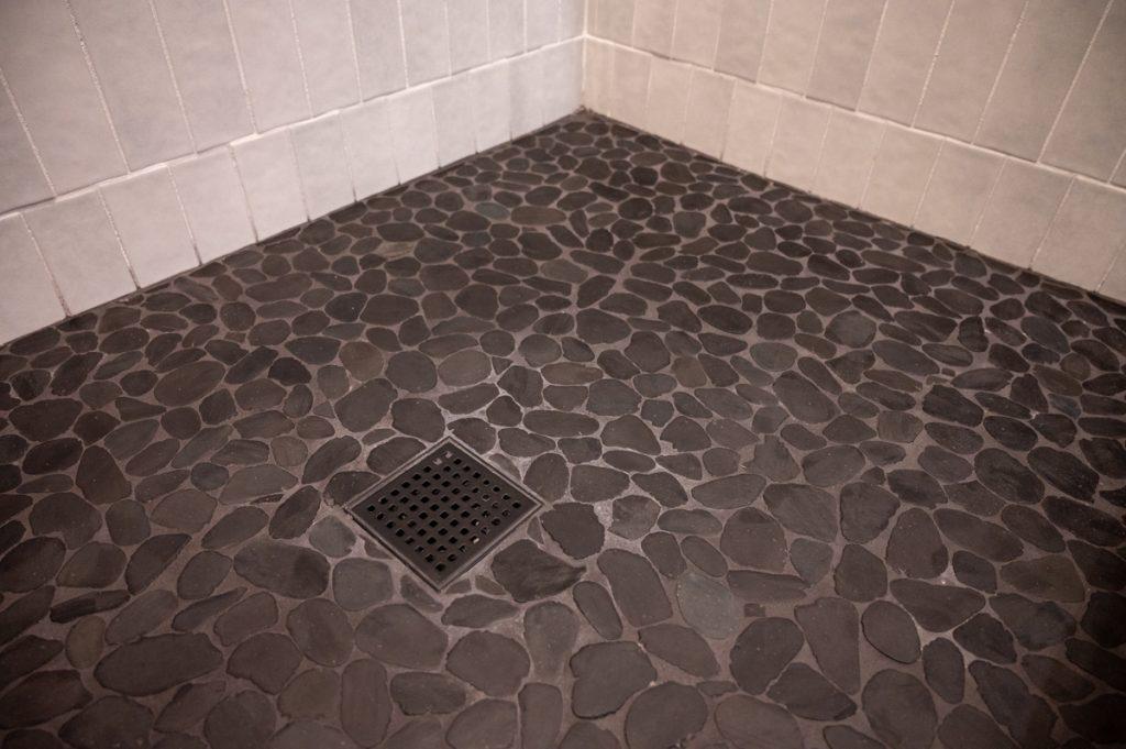 Finished basement stone floor for walk-in shower in bathroom in Novi, Michigan