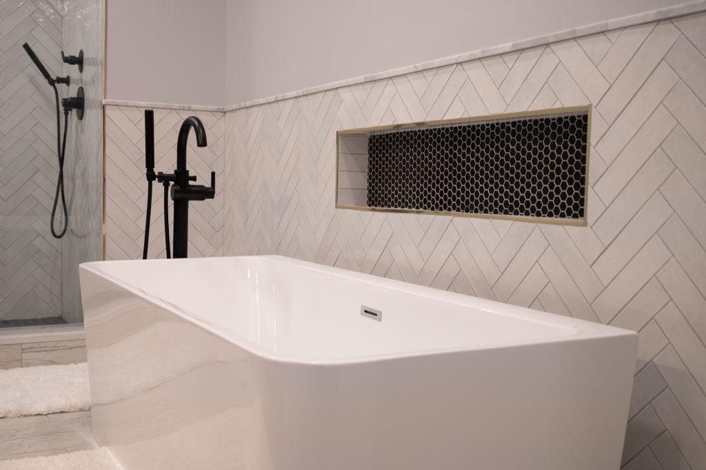 Finished basement bathroom with niche tile and large bathtub in Bloomfield Hills, Michigan