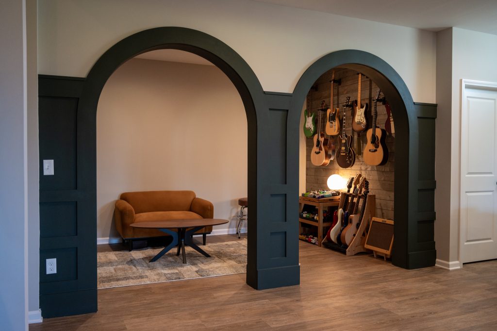 Basement with arched doorway, highlighted by gray accents for added dimension