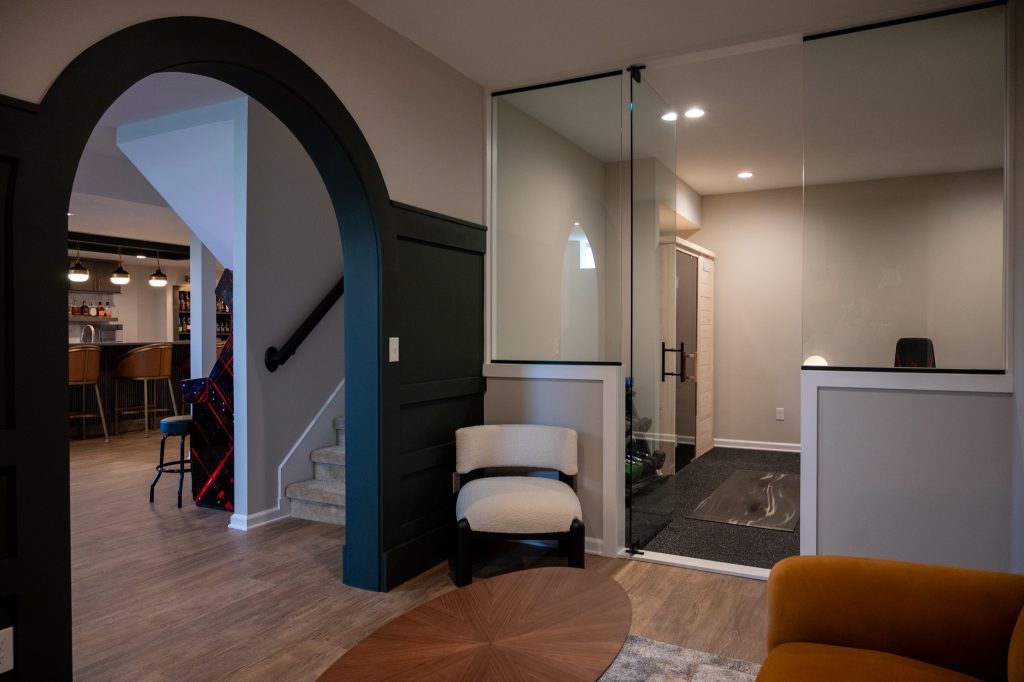 Oakland Township. Basements Plus finished basement showing sauna and workout room with bench and barbell rack.
