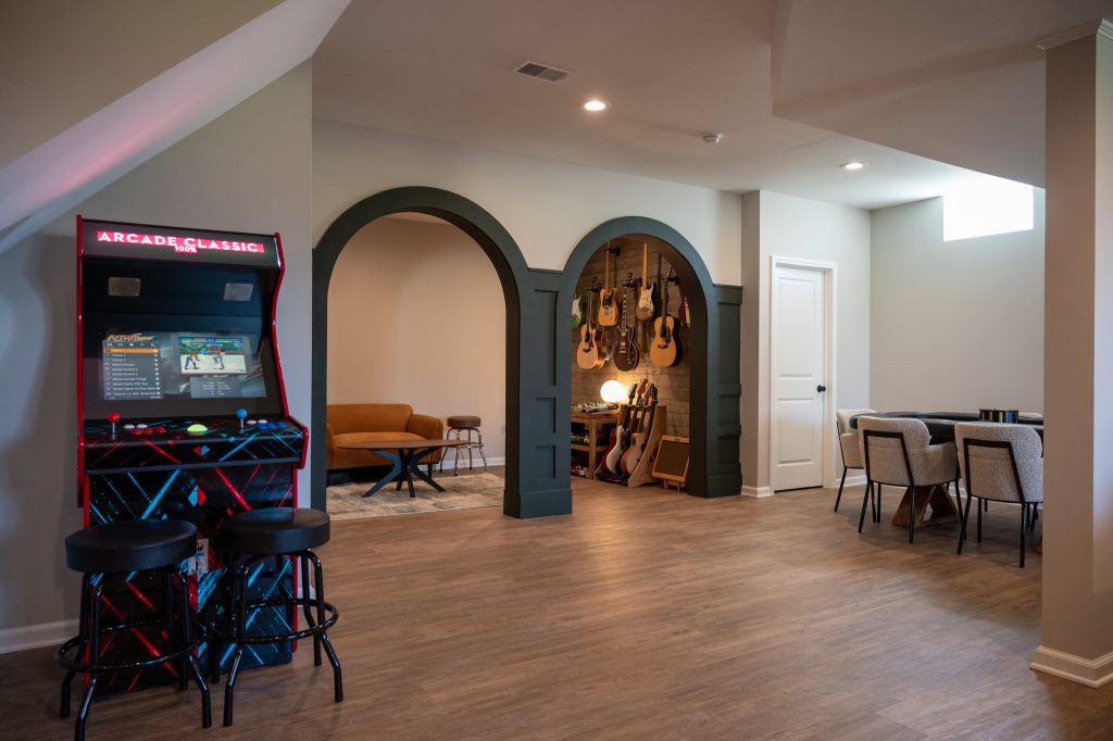 Basement with arched doorway, highlighted by gray accents for added dimension