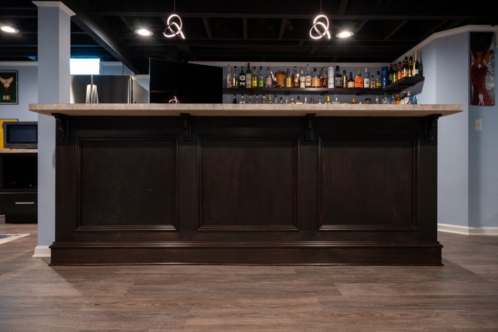 Dark wood bar and modern lighting - remodeled by Basements Plus.