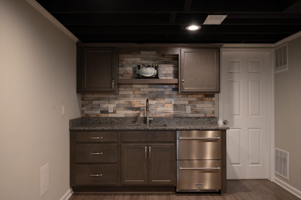 Wet bar in renovated basement by Basements Plus