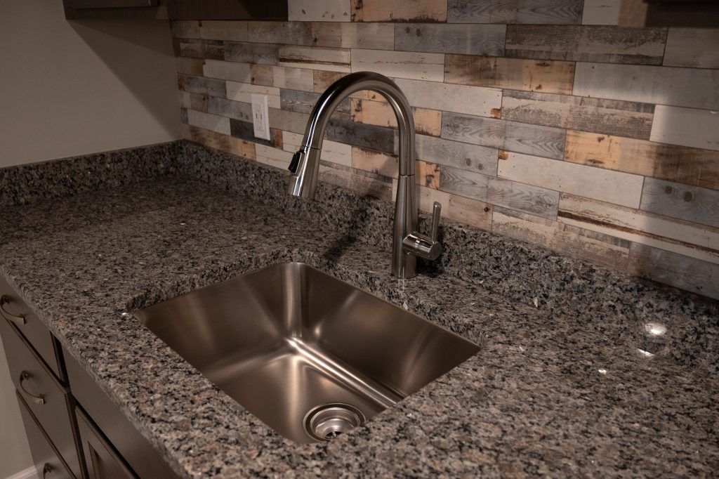 Wet bar in renovated basement by Basements Plus
