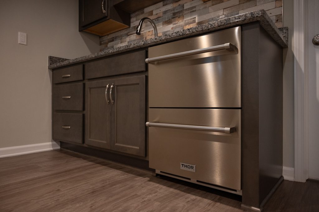 Wet bar in renovated basement by Basements Plus