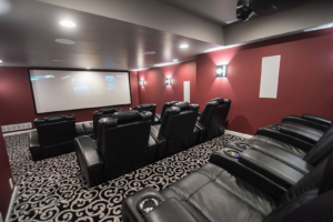 Basement home theater with projector and stadium seating